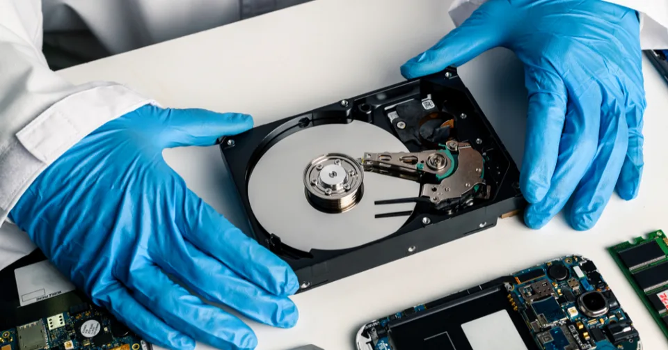 Forensic technician repairing a hard drive